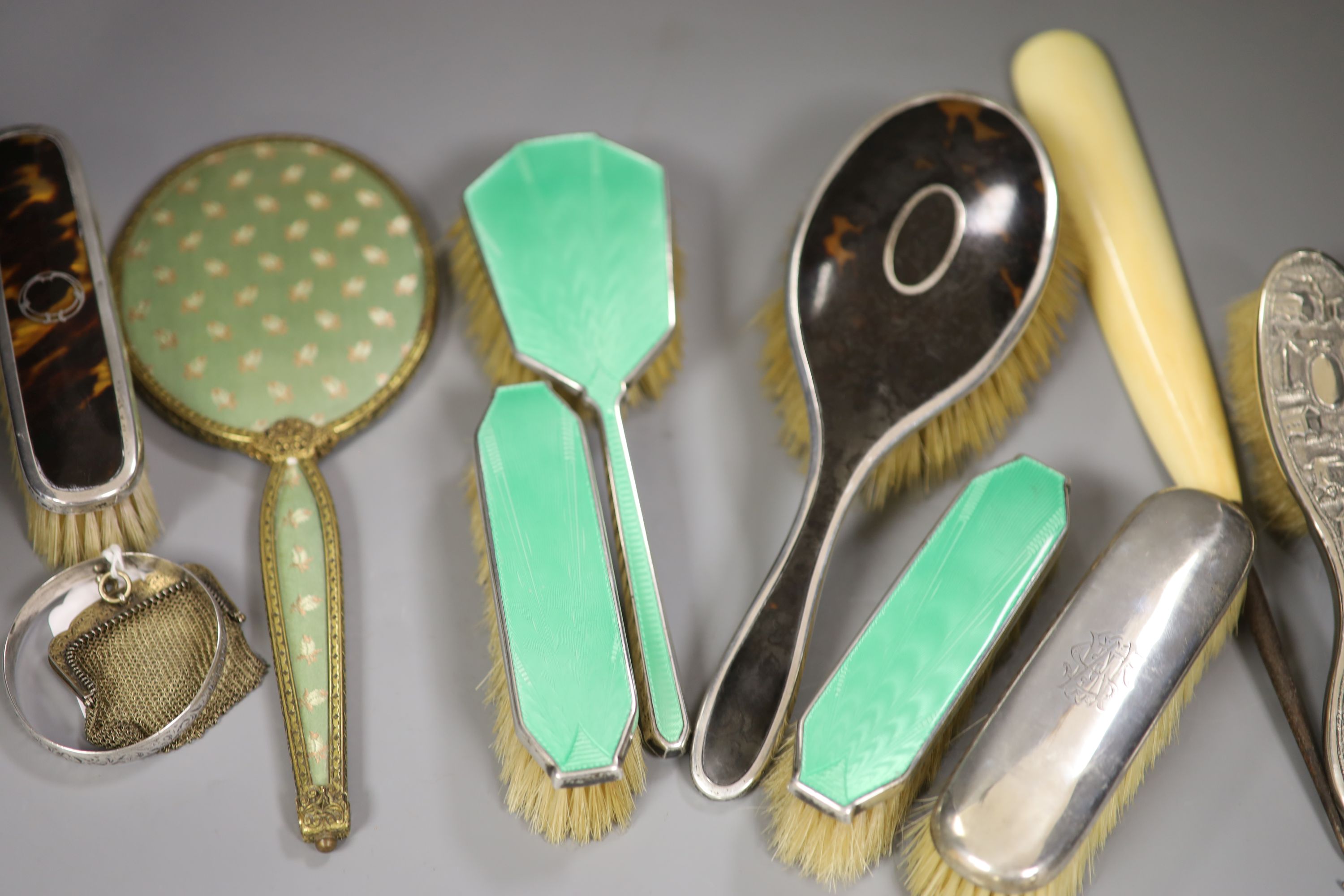 A guilloche enamel and silver-mounted three-piece brush and comb set, three other silver-mounted brushes and five other items,